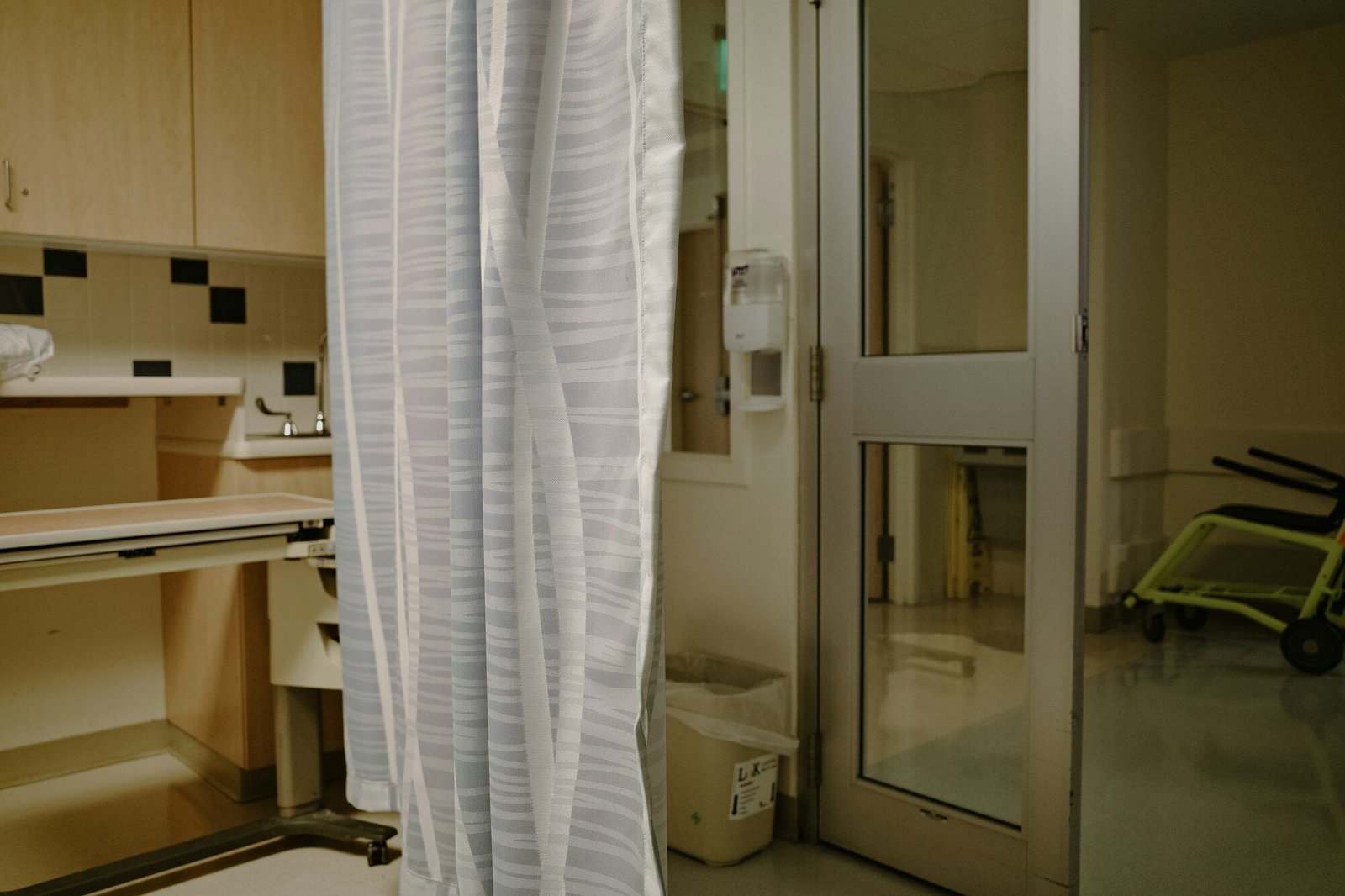 Hospital room with medical equipment and curtain