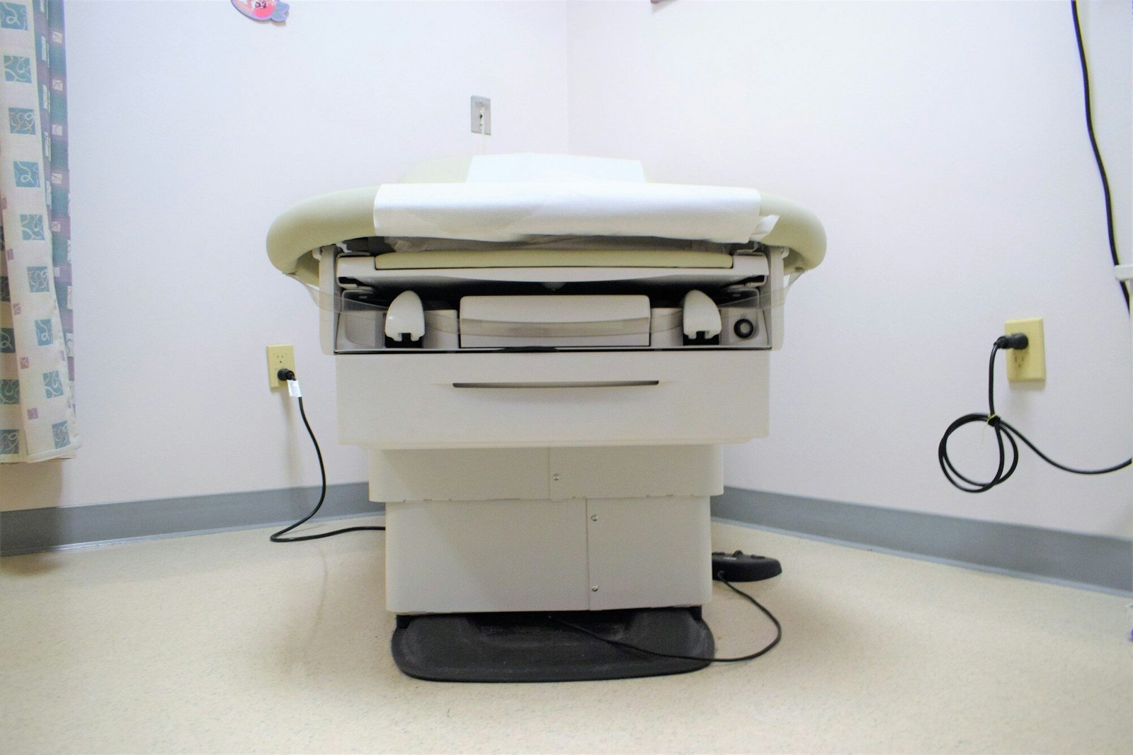 a hospital room with a bed and a charger