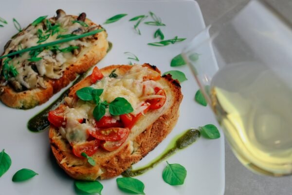 bread with tomato and cheese on white ceramic plate