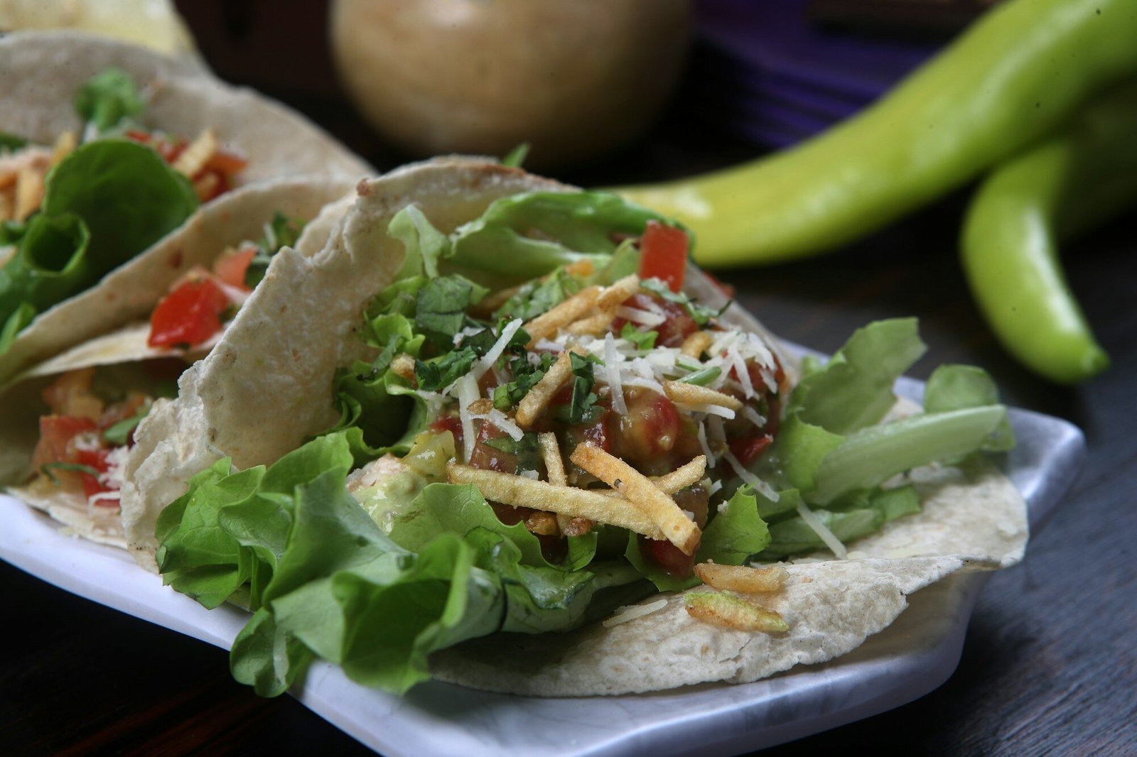 a couple of tacos sitting on top of a white plate