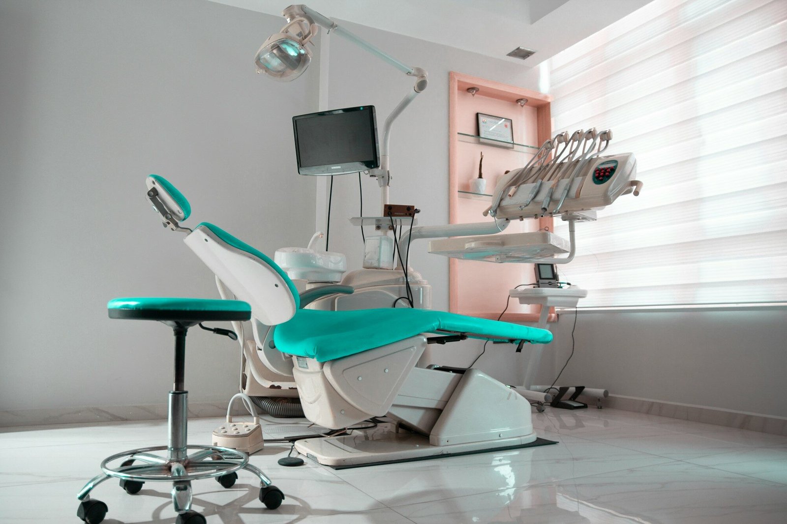 a dental room with a chair and a monitor