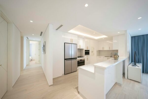 A kitchen with a refrigerator freezer sitting next to a window